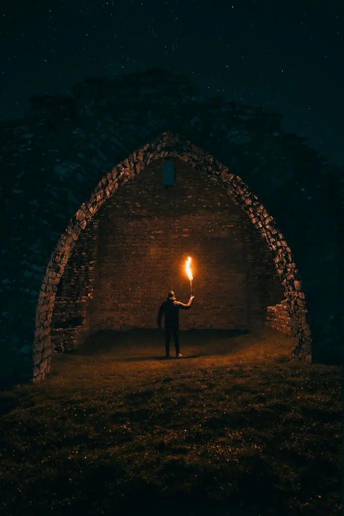 person holding torch in building interior